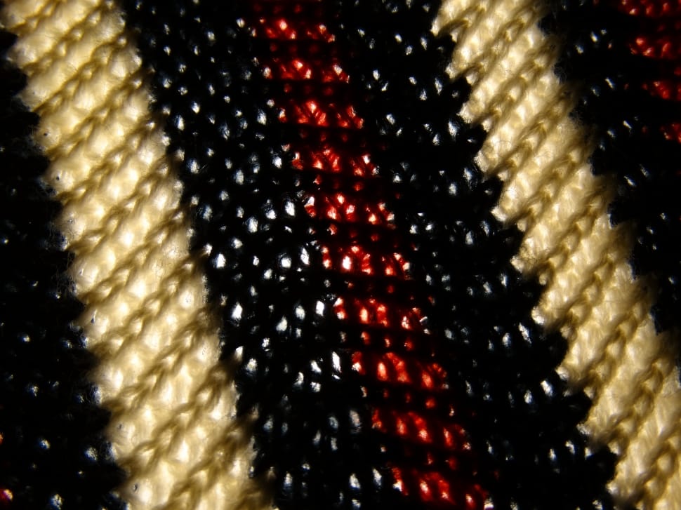 black red and beige knitted textile preview