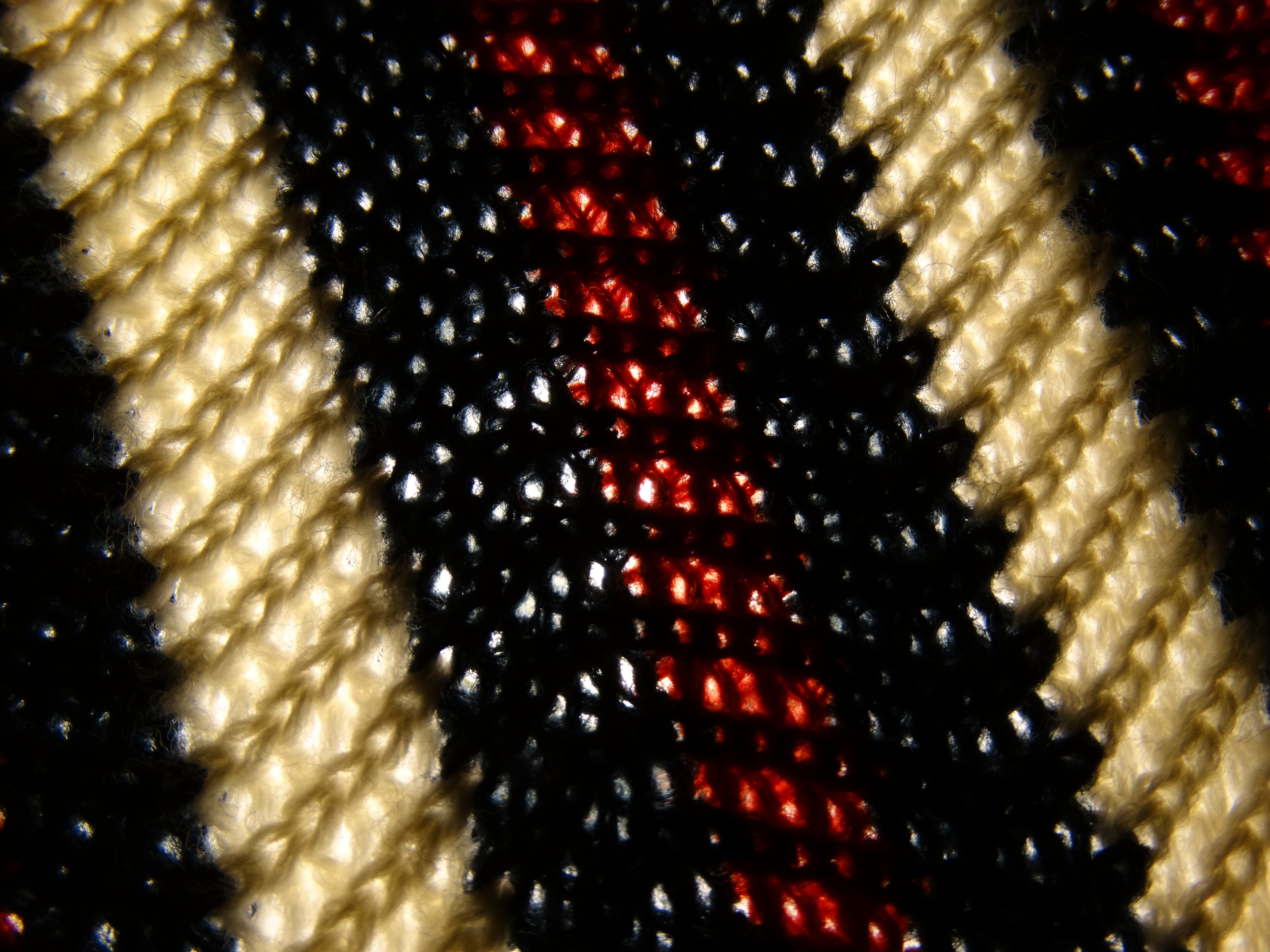 black red and beige knitted textile
