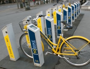 1 parked yellow city bike thumbnail