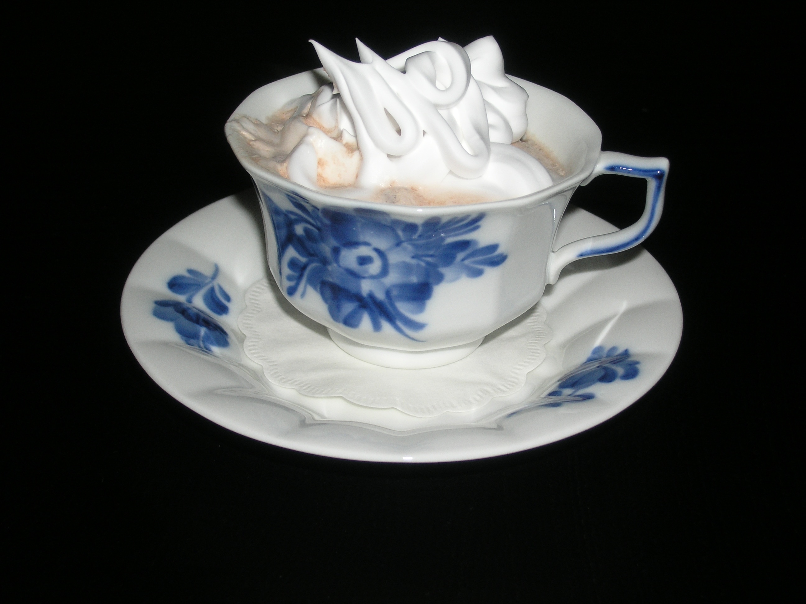 white and blue ceramic teacup and saucer