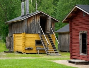 yellow and brown wood storage house with stairs thumbnail