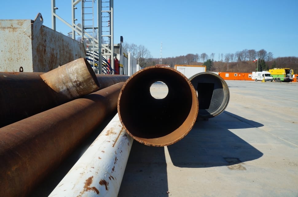 brown and white steel pipe fittings under sunny sky preview