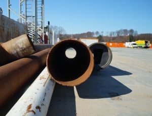 brown and white steel pipe fittings under sunny sky thumbnail