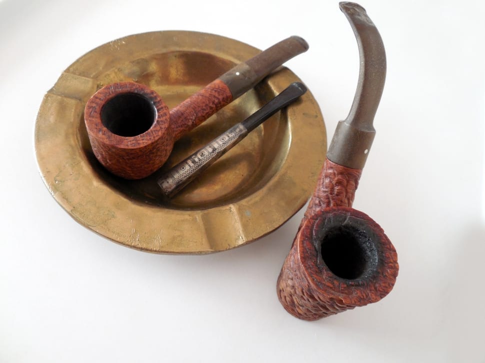 2 brown and red smoking pipes, brown ashtray preview