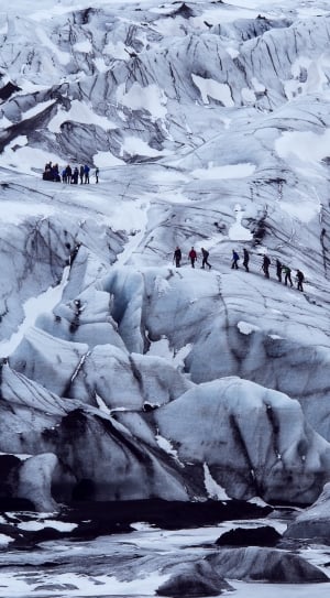 people on ice mountainn near body of water thumbnail