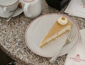 brown and white sliced cake on white plate beside fork thumbnail