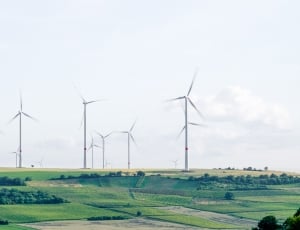 capture image of wind mills during day time thumbnail