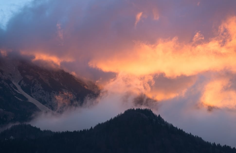 mountain covered with clouds under sunset during daytime preview