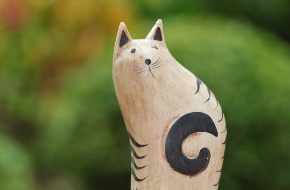 beige and black cat wooden figurine preview