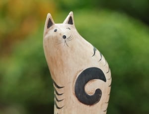 beige and black cat wooden figurine thumbnail