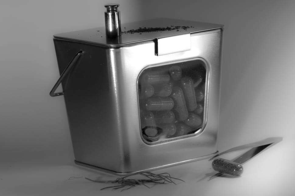 square gray metal container filled with capsules preview