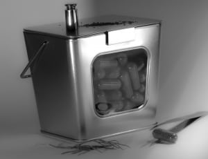 square gray metal container filled with capsules thumbnail