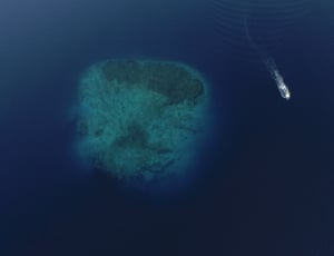 aerial photo of ship near island thumbnail