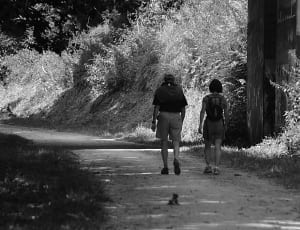greyscale photo of woman and man walking thumbnail