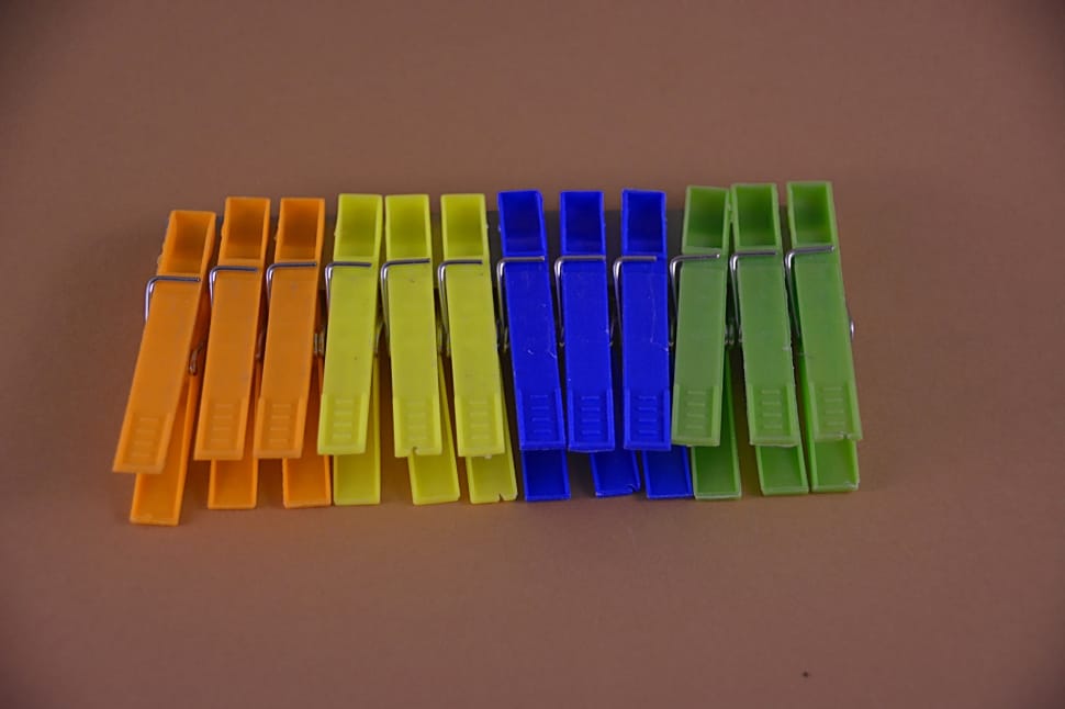 orange yellow blue and green plastic clothes pin preview