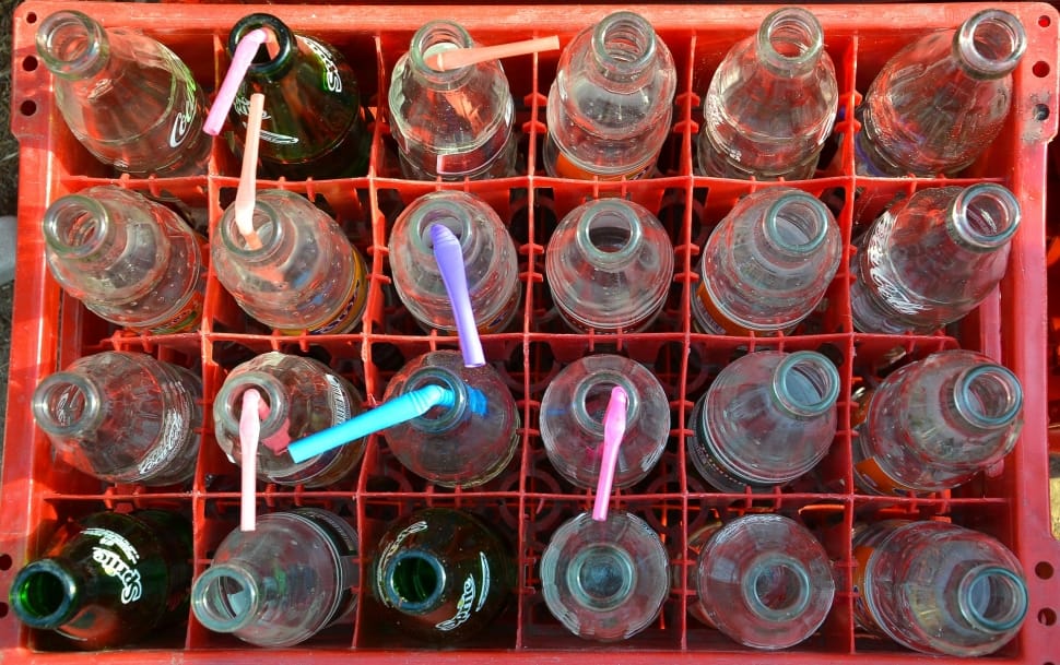 glass bottles with straws and red plastic crate preview