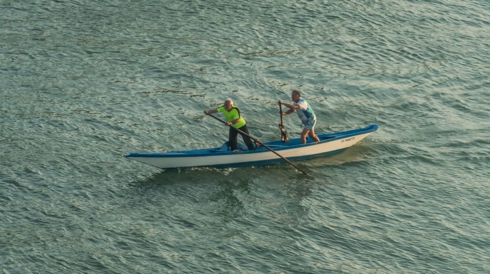 2 persons on blue and white canoe preview