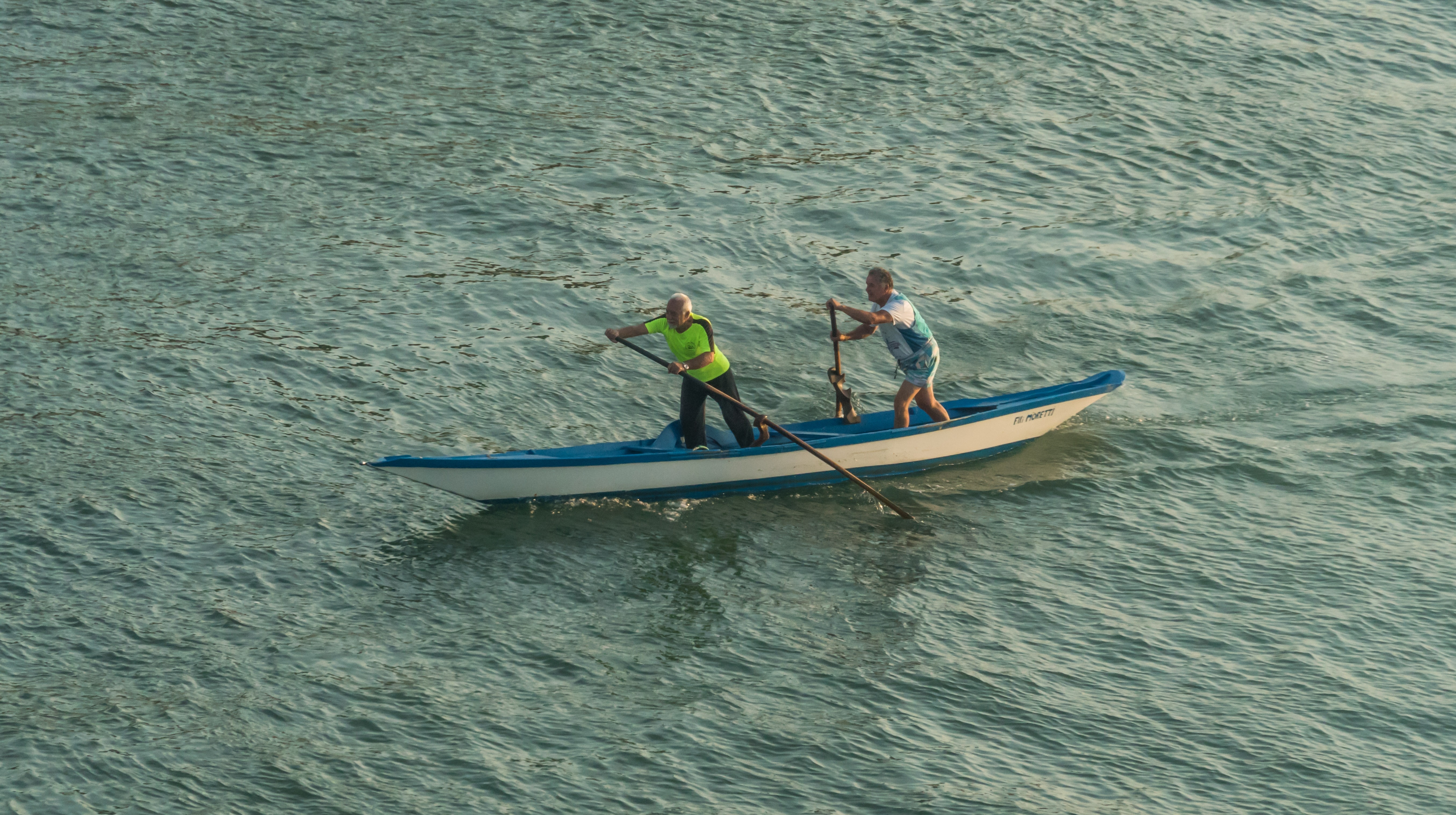 2 persons on blue and white canoe
