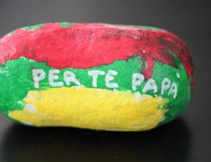 red green and yellow perte papa decorative oval stone thumbnail