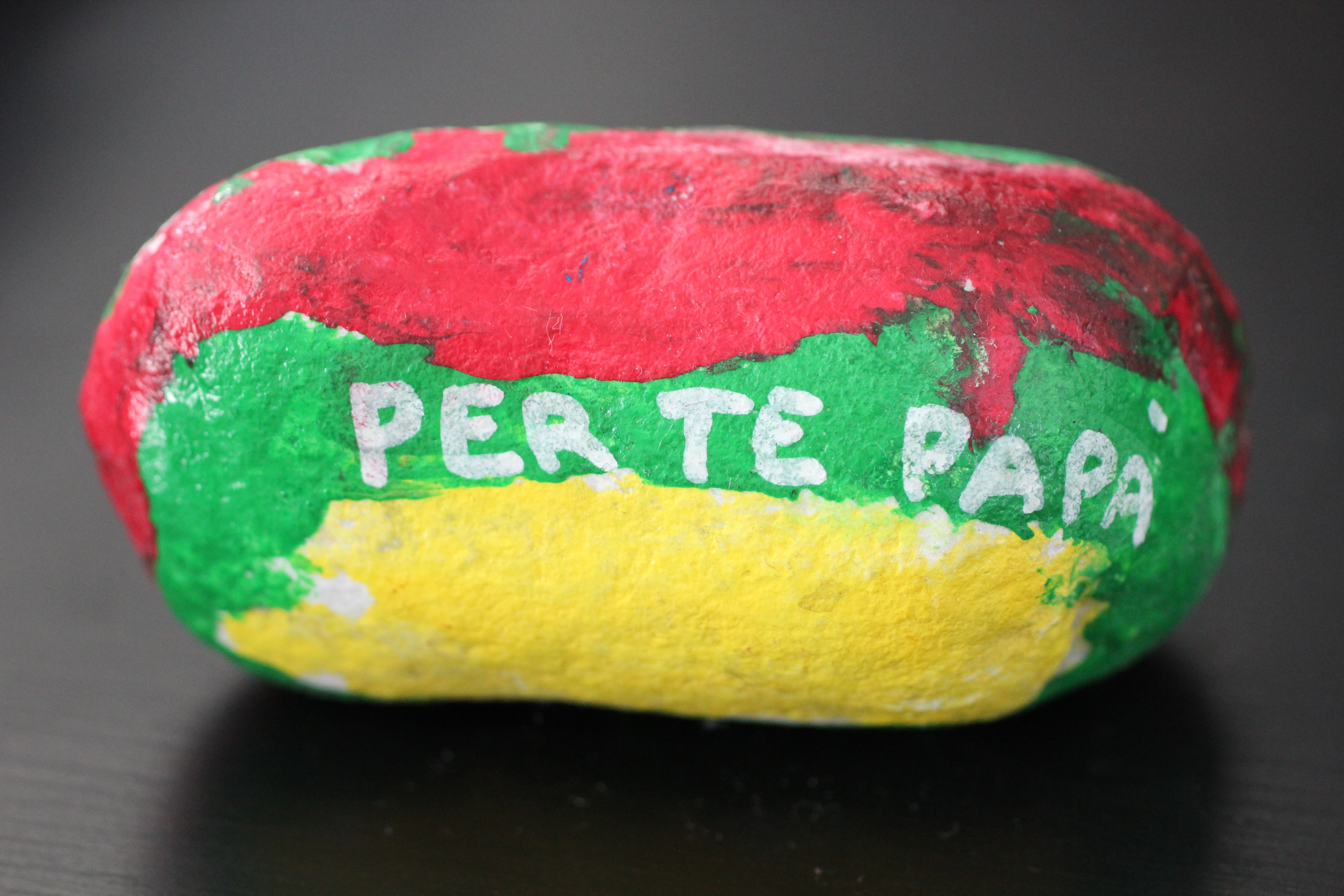 red green and yellow perte papa decorative oval stone