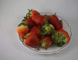 strawberries fruit and white ceramic saucer thumbnail