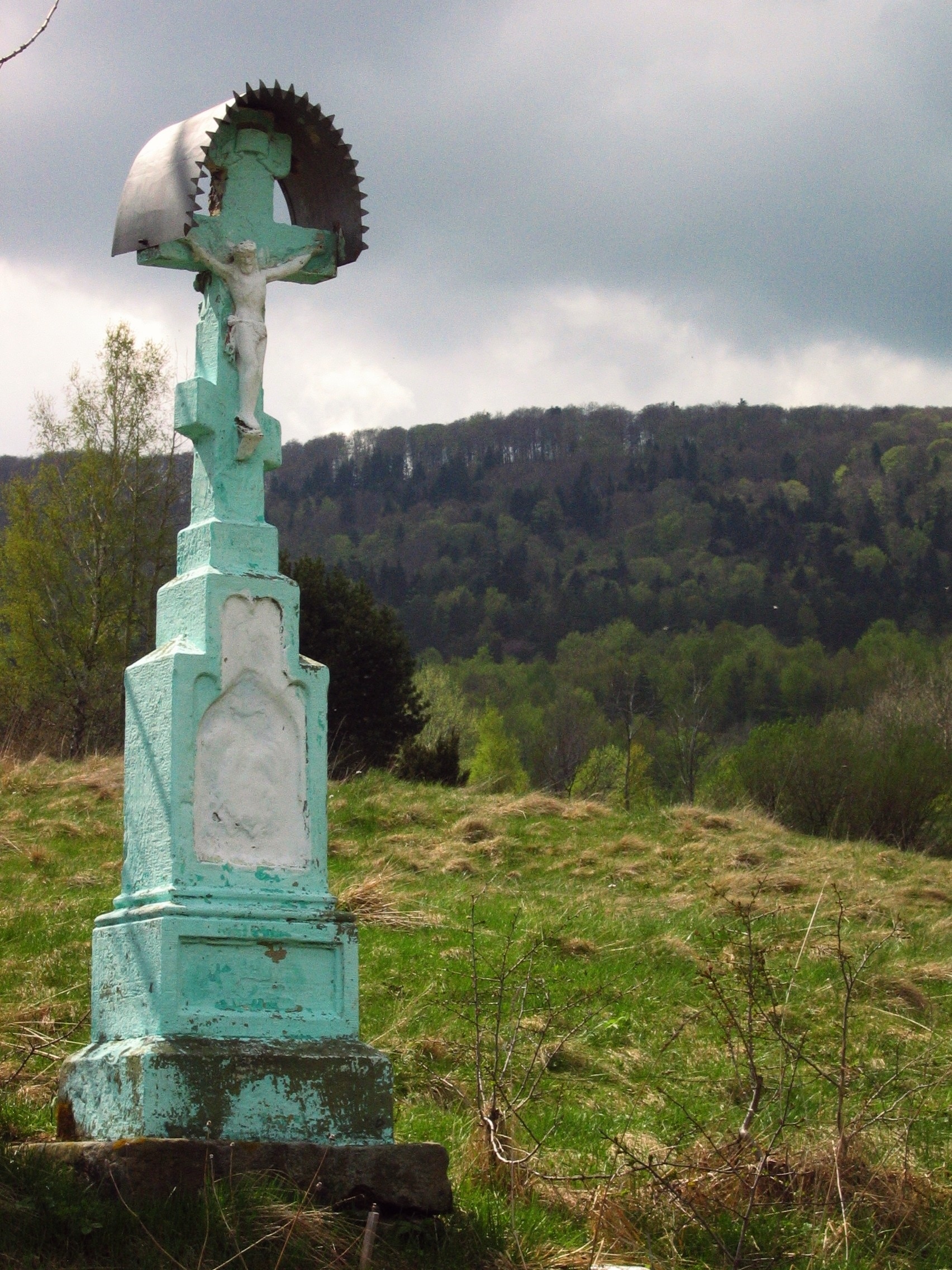 teal and white crucifix statue