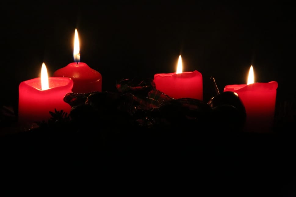 4 red lighted stick candles preview