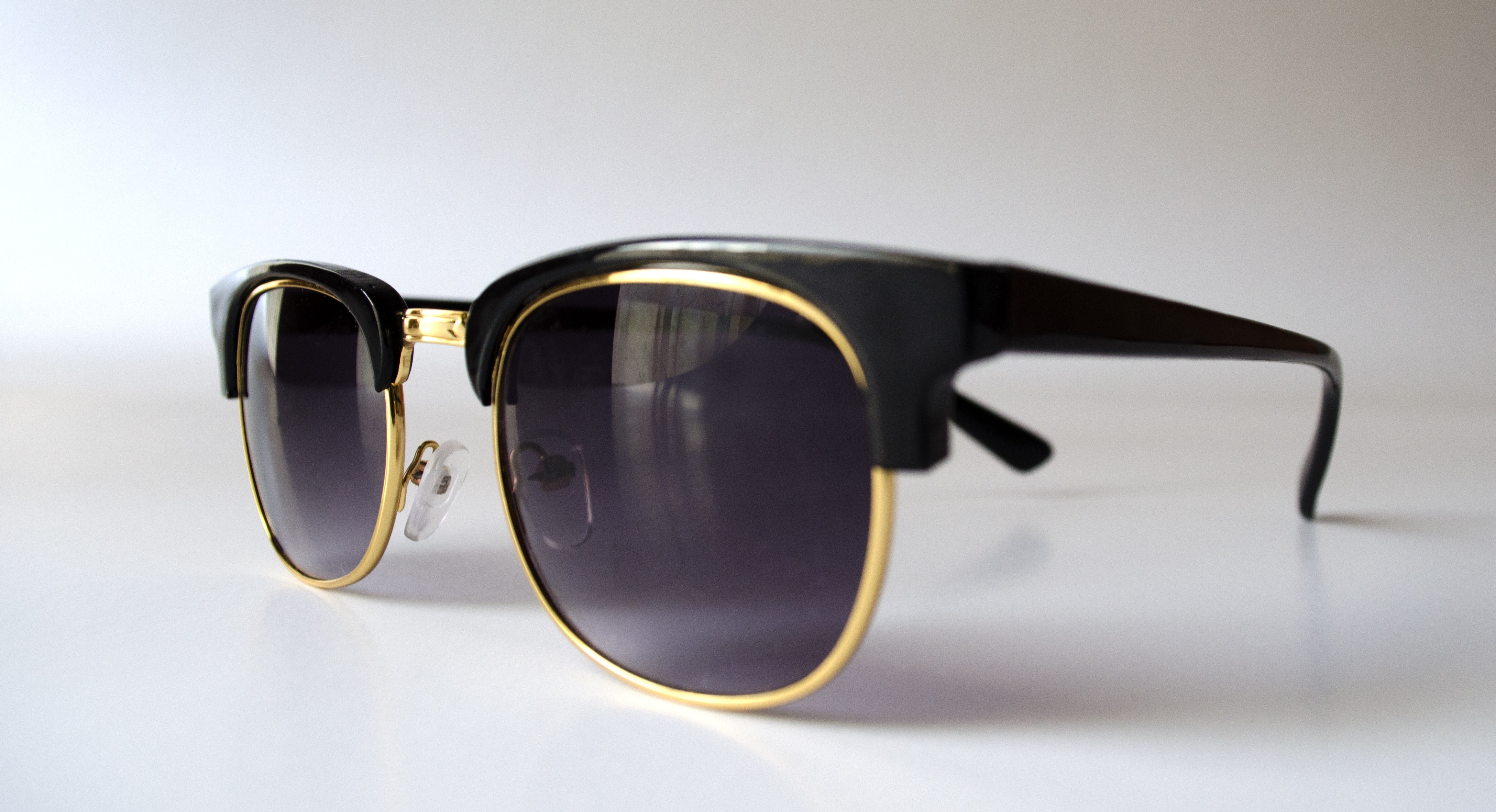 black and gold framed black lens clubmaster sunglasses
