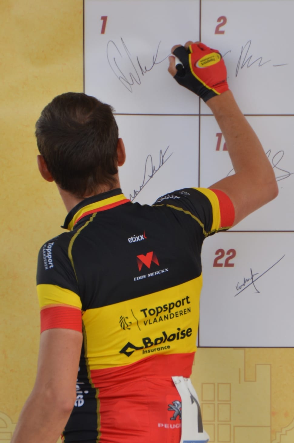 white board;men's yellow,black, and orange collared jersey shirt preview