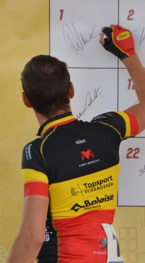 white board;men's yellow,black, and orange collared jersey shirt thumbnail