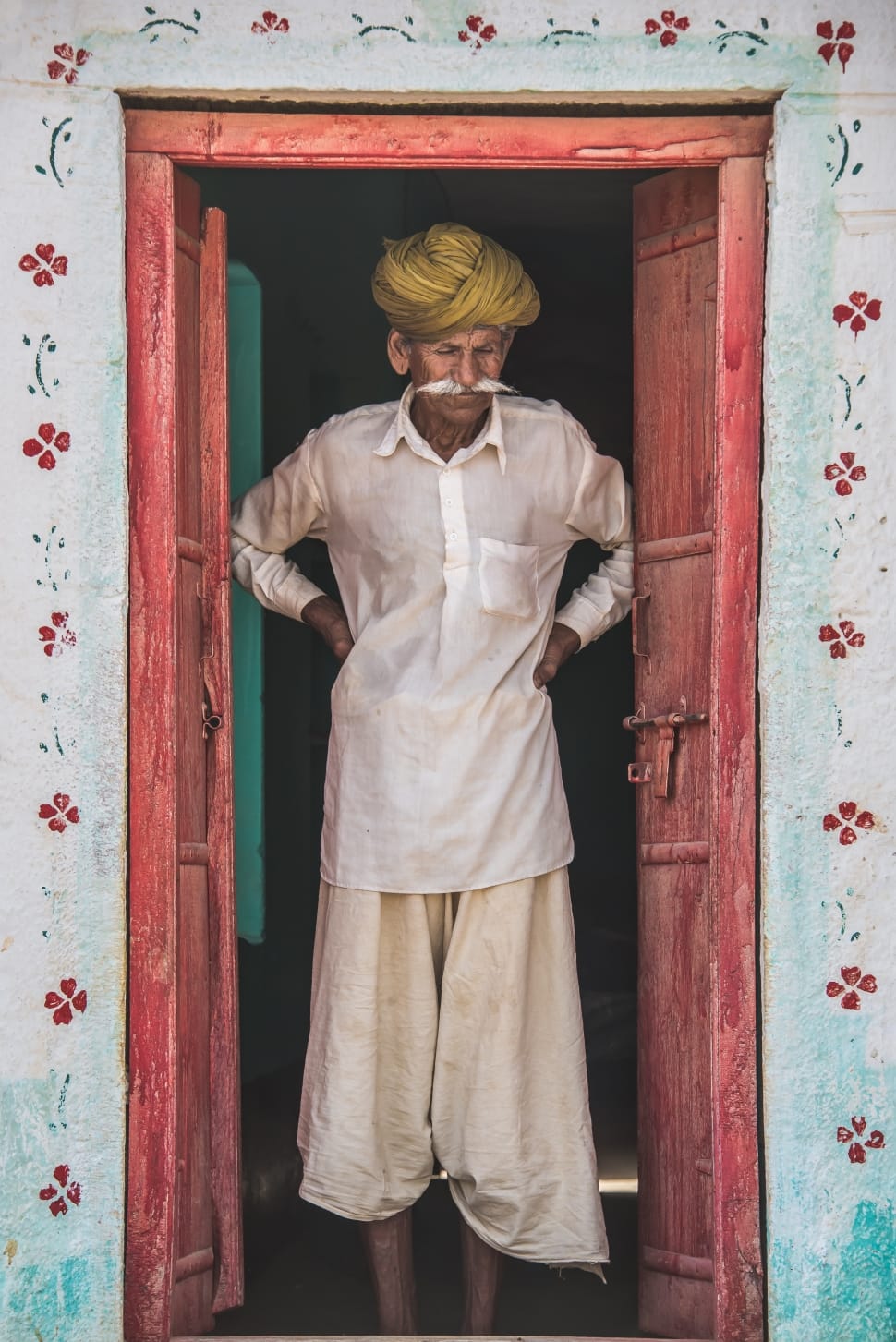 man in white half button long sleeve shirt and beige pants inside building preview