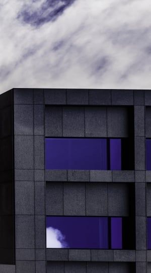 black concrete building with blue tinted glass windows thumbnail