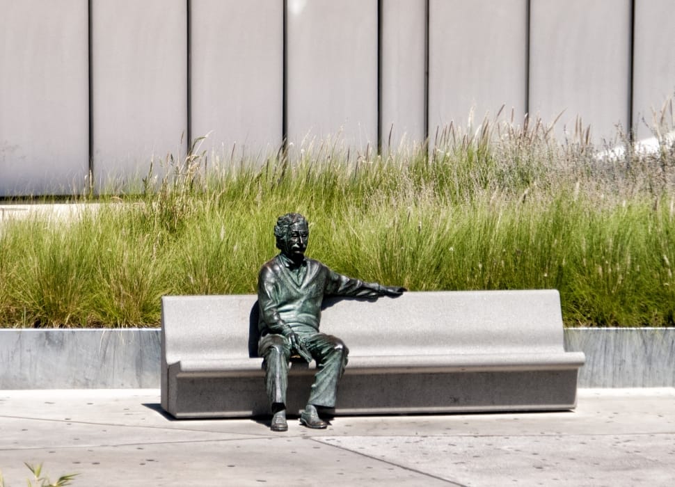 man sitting on bench statue preview