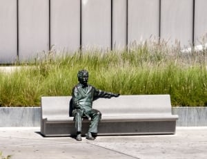 man sitting on bench statue thumbnail