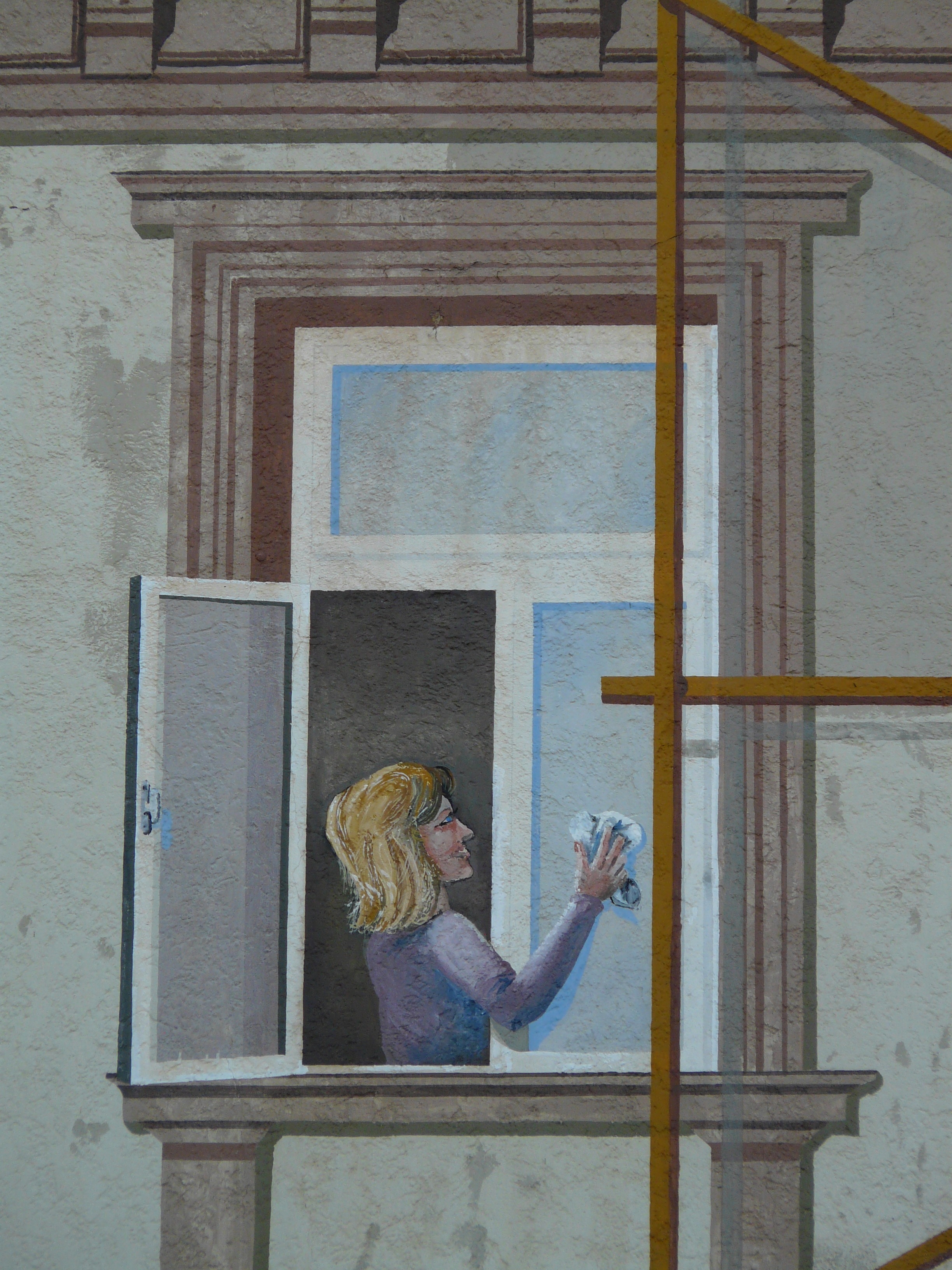 woman cleaning window painting