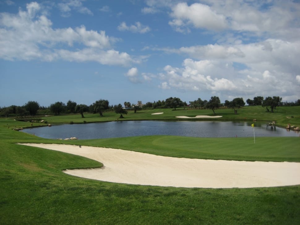 gold course under white and blue cloudy sky preview