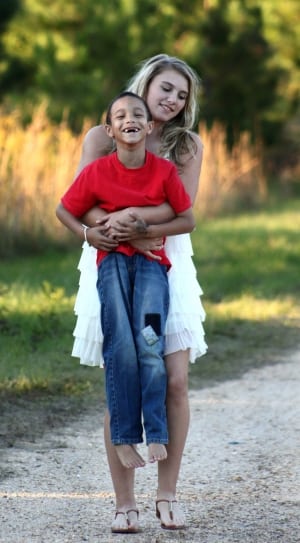 woman wearing white dress and boy wearing red t shirt and jeans thumbnail
