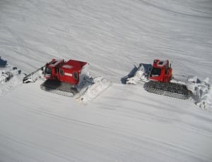 2 red snow trucks thumbnail