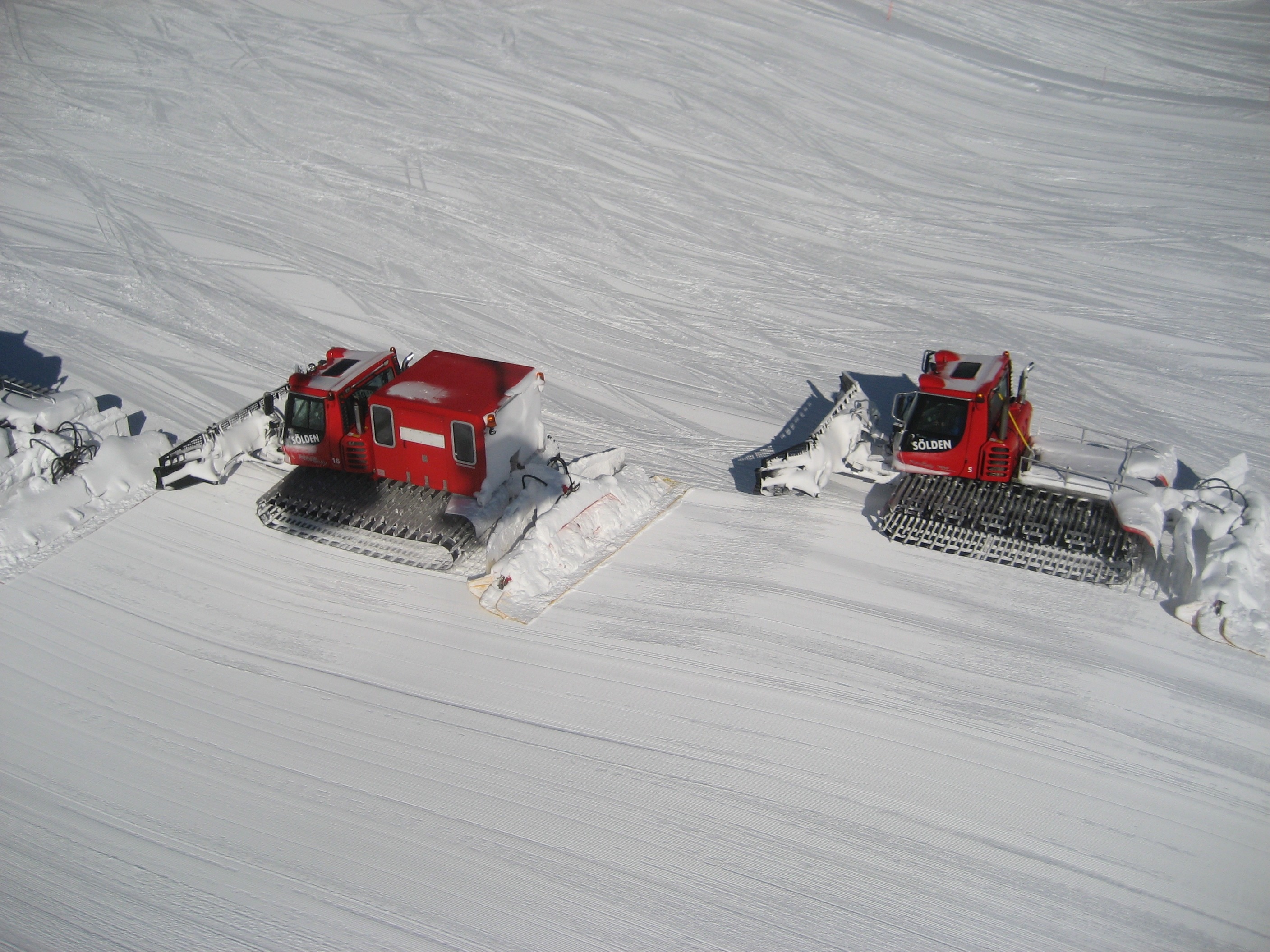2 red snow trucks