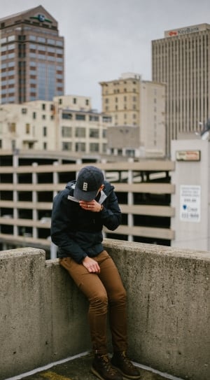 man in black jacket,brown pants on rooftop during daytime thumbnail