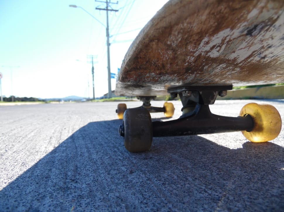 brown skateboard and black trucks preview