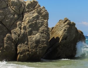 beige rocks beside the ocean thumbnail