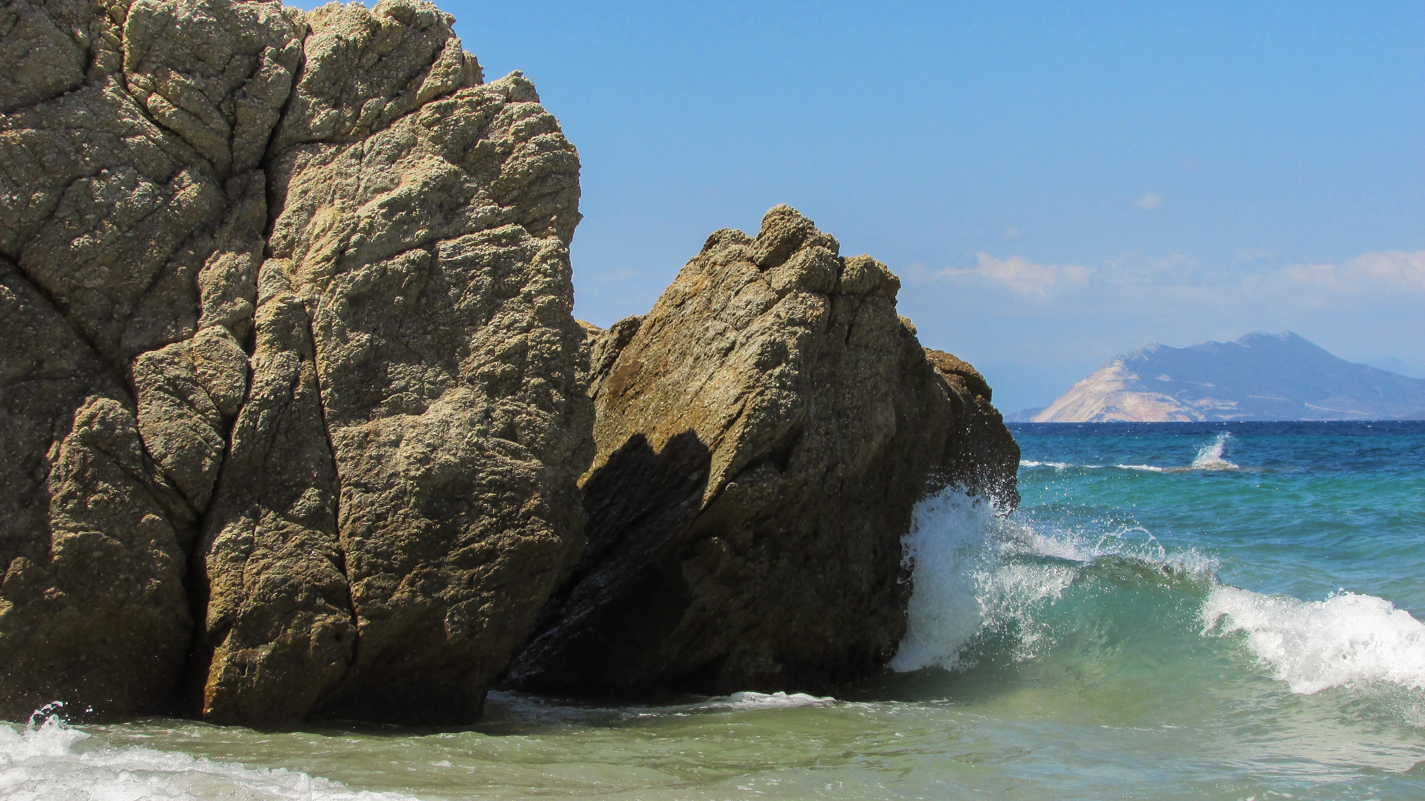 beige rocks beside the ocean