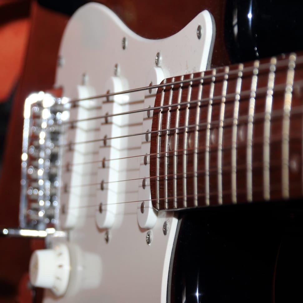 white and brown stratocaster style electric guitar preview