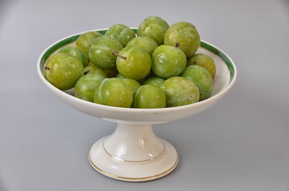 green fruits on white ceramic footed bowl preview