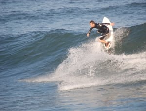 man riding on surfboard during daytime thumbnail