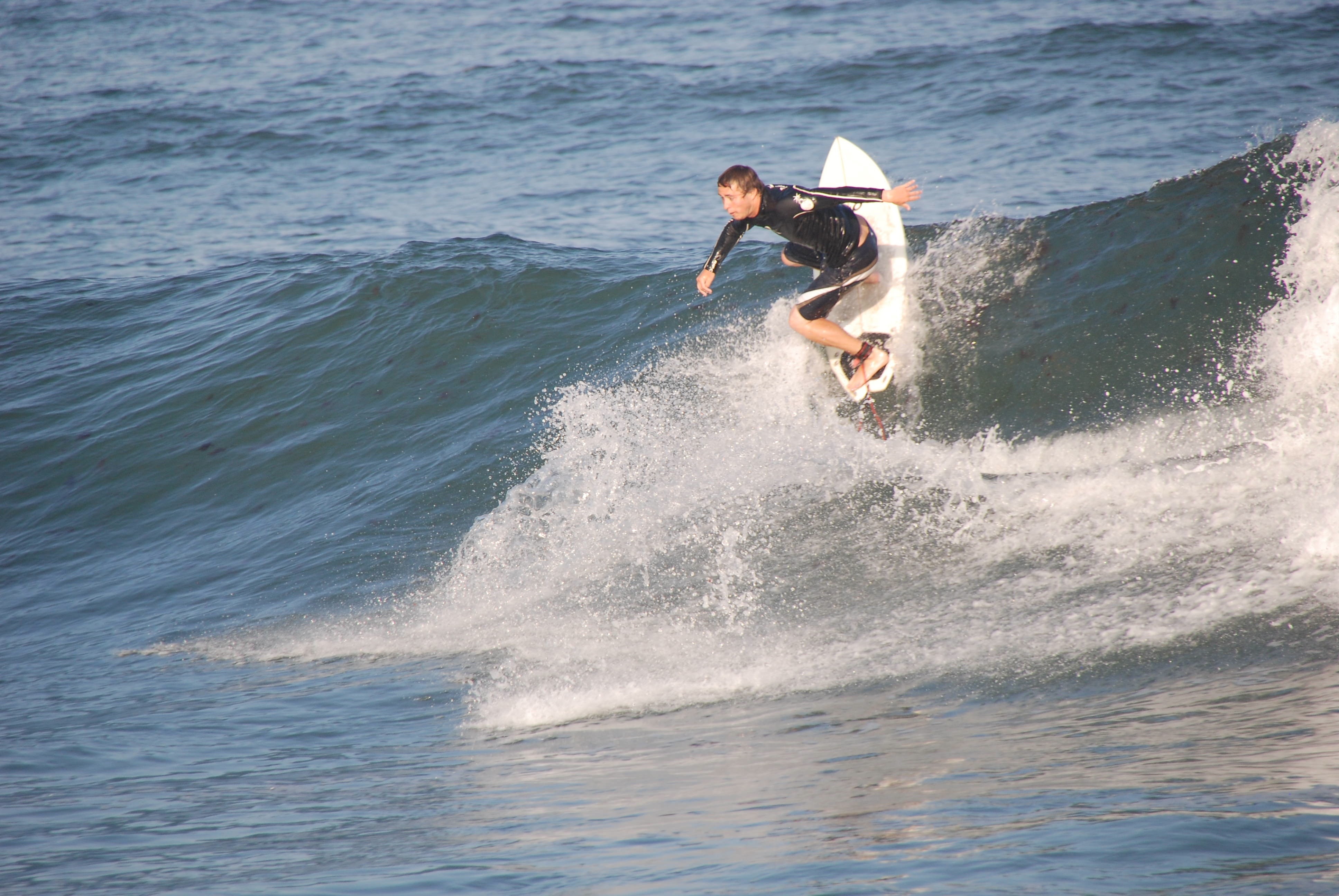 man riding on surfboard during daytime