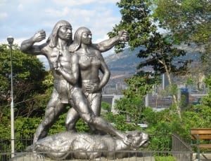 woman and man grey metal statue thumbnail