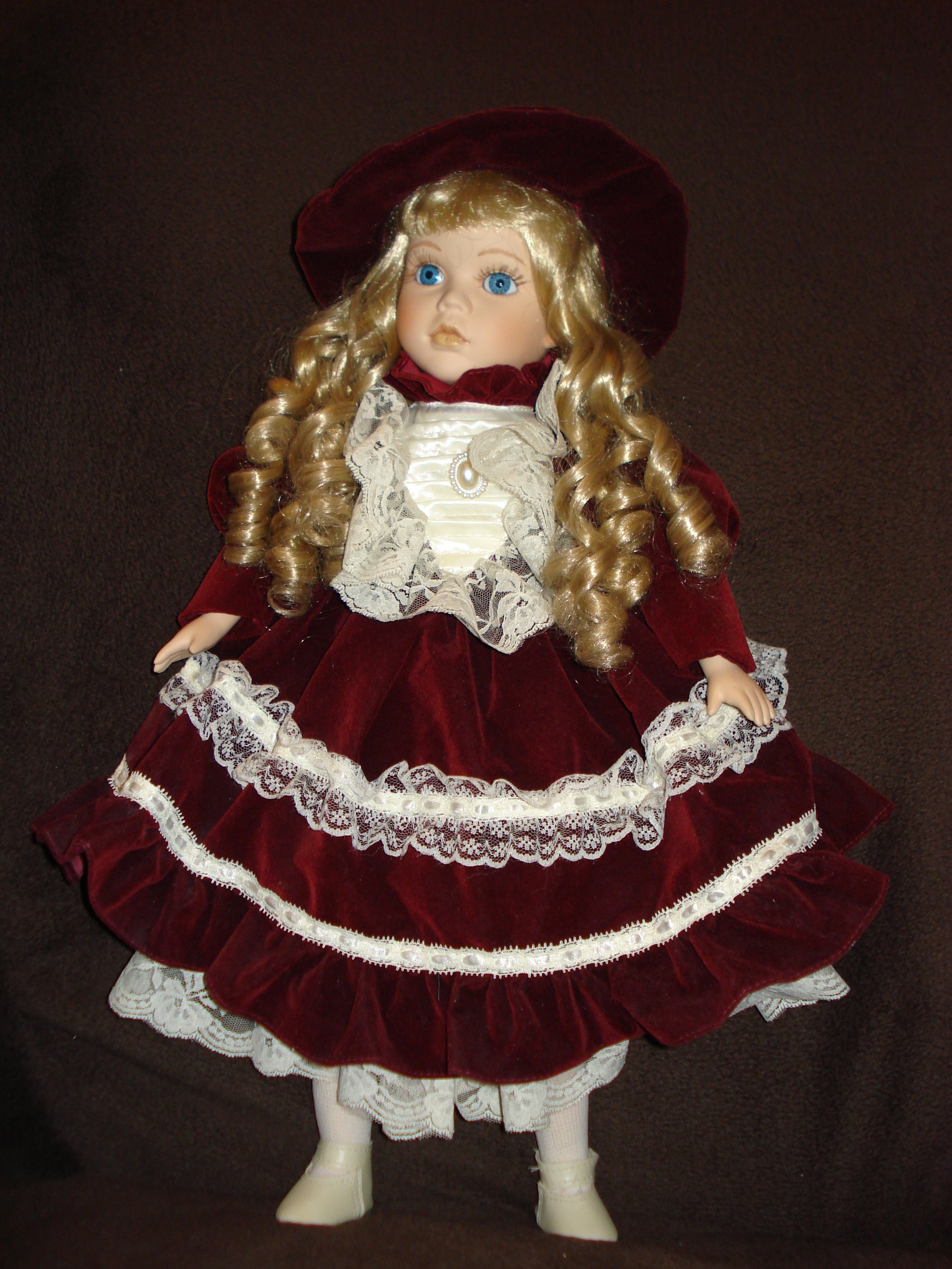 girl wearing red and white long sleeve dress doll