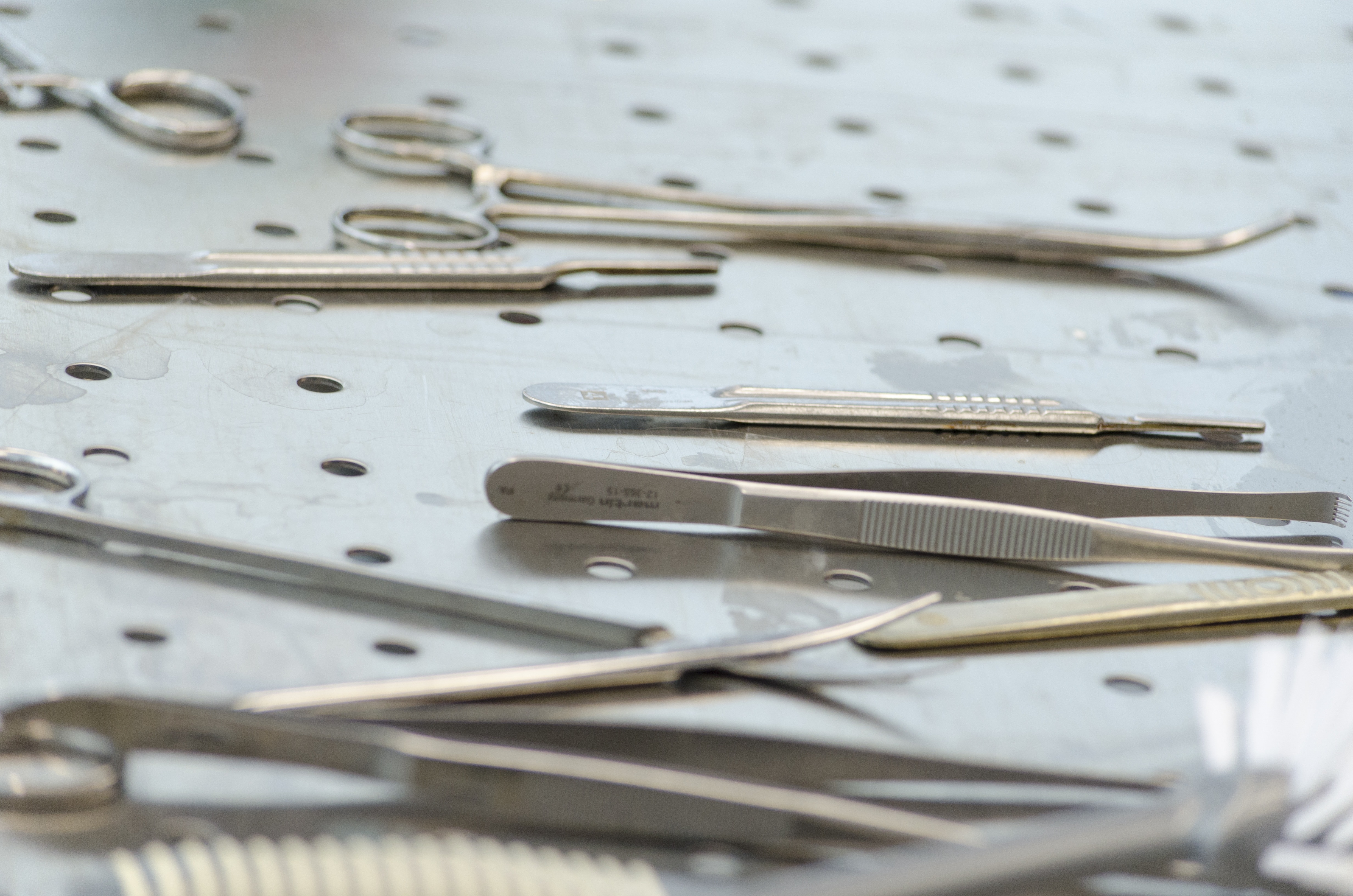 assorted stainless steel medical tools on tray